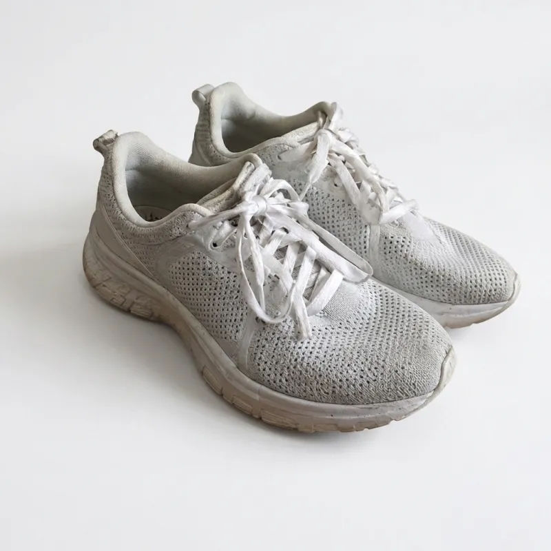 Sneakers on a messy desk moved onto a clean white studio background